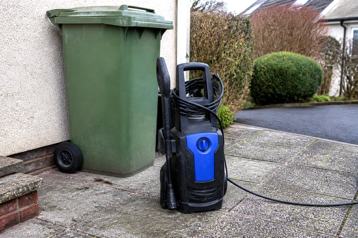 Compact pressure washer on a small yard
